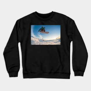 Snowboarder jumping against blue sky Crewneck Sweatshirt